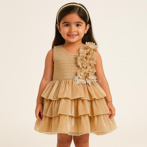 Little Girl In A Elegant Golden Layered Dress With Floral Embellishments